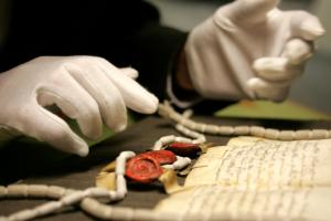reading a manuscript in an archive